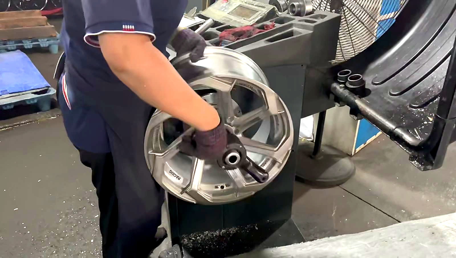 Factory technician checking a wheel during production
