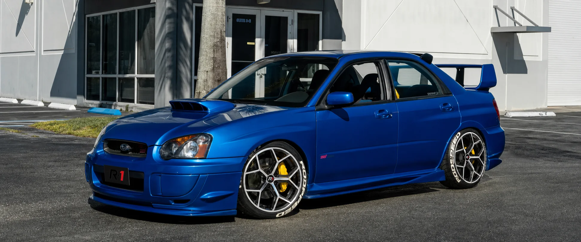 R1 wheel fitment visual on a blue Subaru WRX STI